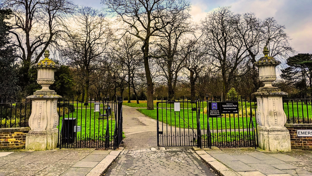 Valentines Park in Gants Hill, East London, with walking trails, a boating lake, and vibrant flower beds on a sunny day.