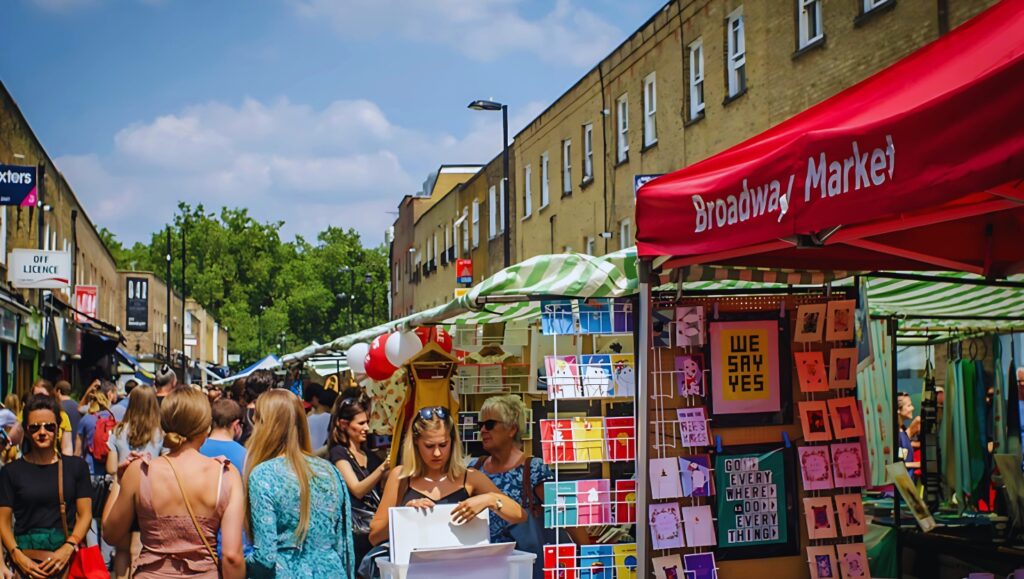 Broadway Market in Hackney, London, bustling with food stalls and shoppers.
